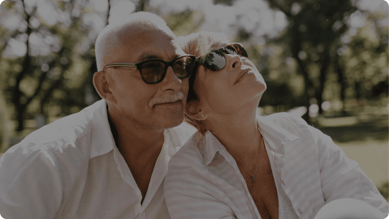 Elderly couple wearing sunglasses outdoors